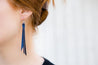 Midnight Braided Leather Fringe Earrings shown on model's ear