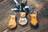 Mountain and forest bottle opener key fobs on countertop with keys attached