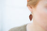 English Tan Small Leather Petal Earrings shown on model's ear