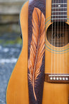 Details of hand carved and tooled feather on leather guitar strap