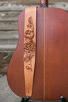 Details of hand-carved peony flower design on leather guitar strap.