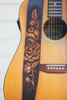Details of hand-carved peony flower design on leather guitar strap. 