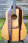 Hand carved leather Sheridan rose guitar strap shown on guitar