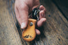 Model holding leather mountain key fob with keys attached