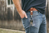 Man wearing mahogany leather key fob on his belt 
