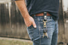 Man wearing black leather key fob on his belt 