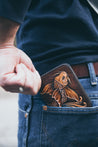 Man pulling handcrafted leather koi wallet out of his back pocket