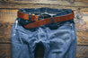 Handcrafted leather Legacy belt looped through a pair of jeans 
