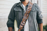 Man with guitar modeling leather Skulls and Roses Extended Edition guitar strap