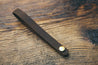 Hand-crafted guitar neck adapter strap in brown with brass hardware. 