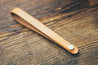 Hand-crafted guitar neck adapter strap in natural with brass hardware. 