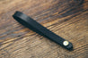 Hand-crafted guitar neck adapter strap in black with brass hardware. 