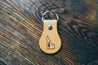 Hand-crafted leather key fob with Idaho state outline and single pine tree embossed on front