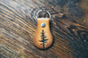 Hand-crafted leather key fob with single pine tree design embossed on front