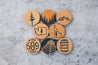Round leather magnets featuring designs inspired by the Pacific Northwest.