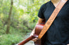 Guitar player modeling Cascadia leather guitar strap