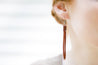English Tan Braided Leather Fringe Earrings shown on model's ear