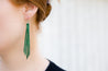 Emerald Braided Leather Fringe Earrings shown on model's ear