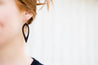 Espresso Cutout Petal Earrings shown on model's ear