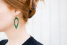 Emerald Cutout Petal Earrings shown on model's ear