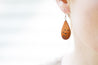 Birds in Flight Tooled Teardrop Earrings shown on model's ear