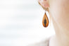 Lodgepole Pine Tooled Teardrop Earring shown on model's ear