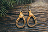 Flat lay view of leather Braided Knot Earrings in Natural