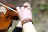 Violin player wearing the leather Feather Cuff Bracelet
