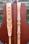 Two options for guitar strap adjustment style - 9 slot or buckle.