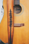 Details of hand carved and tooled lodgepole pine tree on leather guitar strap