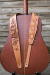 Hand carved peony flower design on leather guitar strap. Strap shown on guitar