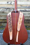 Antiqued Sheridan Rose guitar strap shown on guitar