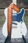 Hand carved Silent Forest leather guitar strap with bare trees and birds nesting in the branches