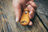 Model holding hand-crafted mountain bottle opener key fob