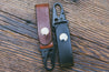 Handcrafted leather key fobs shown in Mahogany and Black