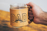 Leather DAD mug held in man's hand. 