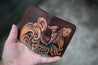 Handcrafted leather wallet with tooled design featuring a koi fish riding a cresting wave