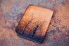 Back detail of  hand-tooled and dyed leather tree wallet