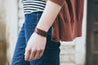 Woman wearing split leather wrap bracelet in English Tan. 
